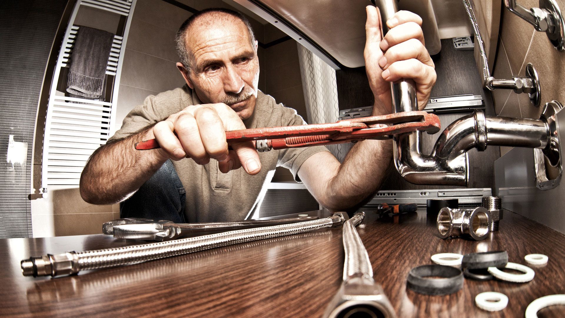 plumber working on pipes